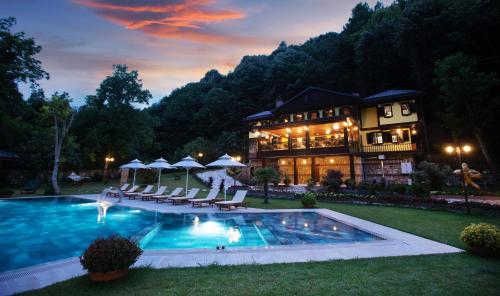 a large house with a swimming pool in the yard at Casa Giallo in Sapanca