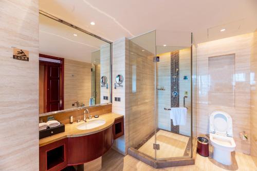 a bathroom with a sink and a shower and a toilet at C&D Hotel,Putian in Putian