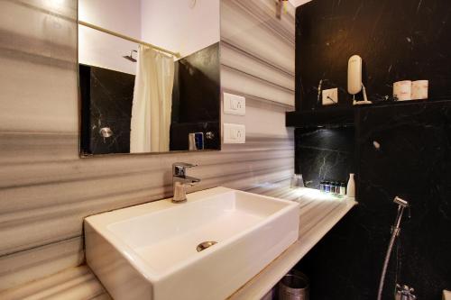 a bathroom with a white sink and a mirror at Panna Vilas - A Lake Facing Boutique Hotel in Udaipur