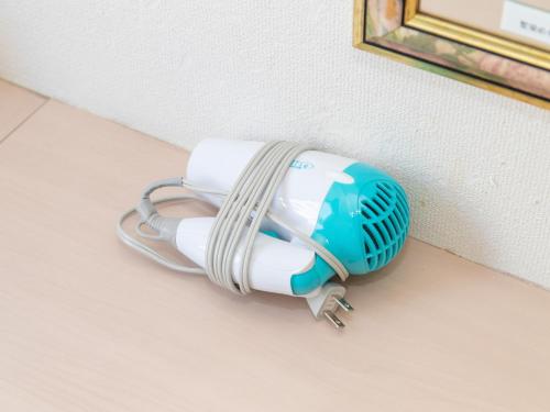 a air conditioner is attached to the side of a wall at Tabist Sasebo Palace Hotel in Sasebo