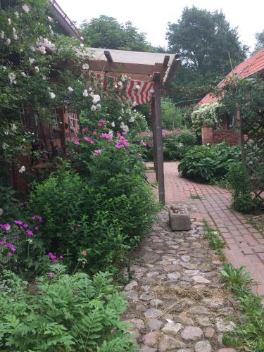 a garden with flowers and a brick walkway at Privelacker Paradiesgarten in Privelack