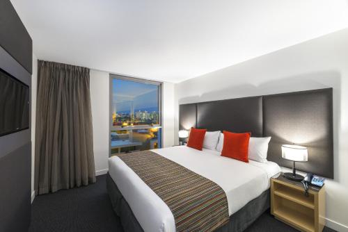 a hotel room with a bed and a large window at Mantra South Bank Brisbane in Brisbane