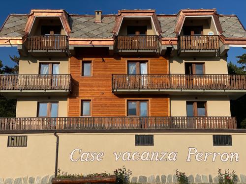 a building with balconies on top of it at Case Vacanza Perron in Sauze dʼOulx