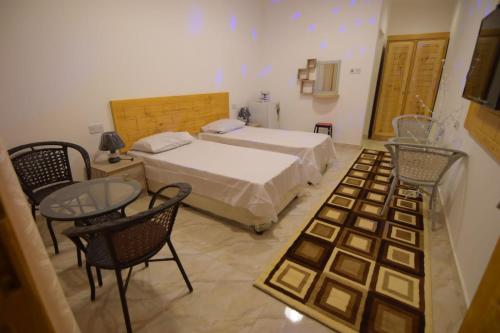 Postel nebo postele na pokoji v ubytování السكون لبيوت الضيافة و شاليه AL Sukun For Guest Houses & Chalet