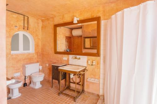 a bathroom with a toilet and a sink and a mirror at Villa Almar in Cala d´Or