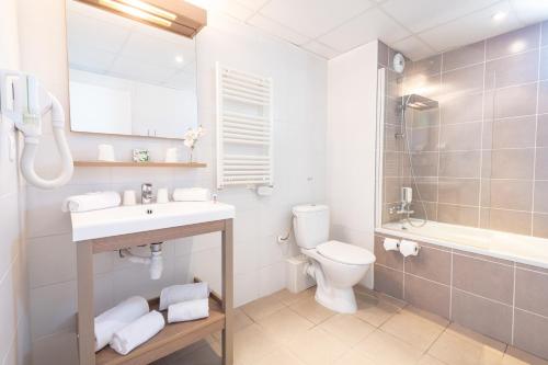 a bathroom with a sink and a toilet and a shower at Comfort Aparthotel Cannes Mandelieu in Mandelieu-la-Napoule