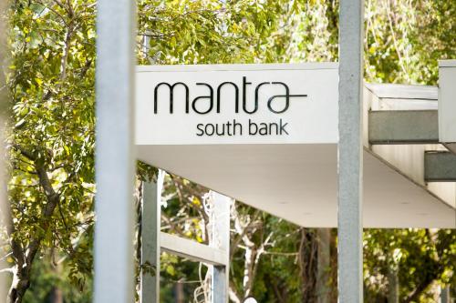 a sign for manta south bank in front of trees at Mantra South Bank Brisbane in Brisbane