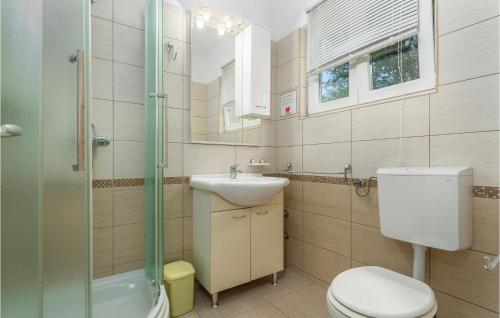 a bathroom with a toilet and a sink and a shower at 2 Bedroom Lovely Apartment In Pinezici in Pinezici
