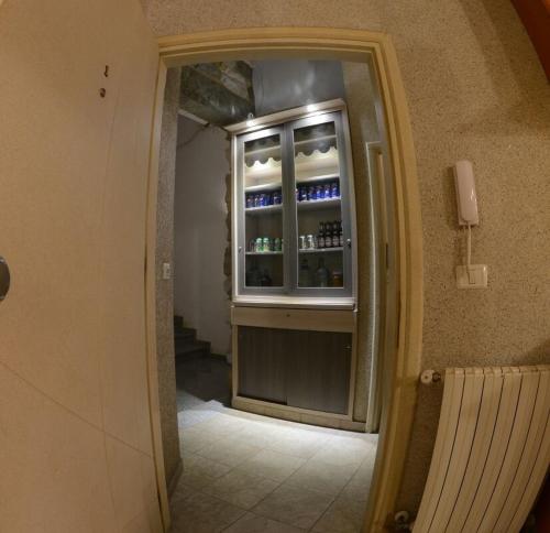 a room with a refrigerator with drinks in it at Bauhaus Motel in Bcharré