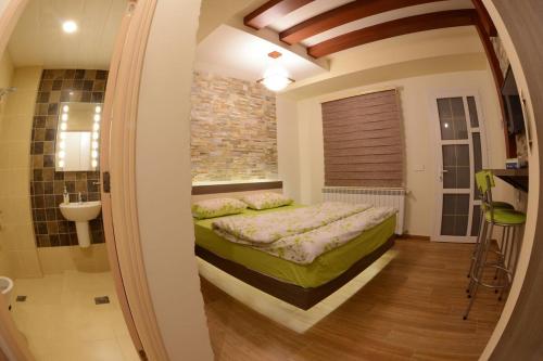 a bedroom with a bed in a room with a window at Bauhaus Motel in Bcharré