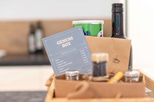 a box with a bottle of wine and a book at Apartment am Grundlsee - Your Austrian Home in Grundlsee