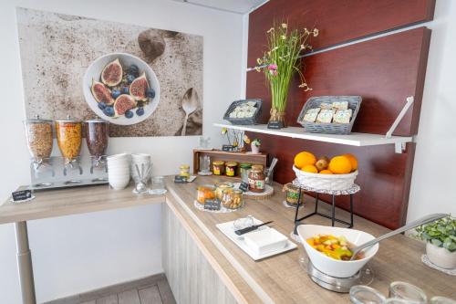 a kitchen with a counter with food on it at Comfort Aparthotel Cannes Mandelieu in Mandelieu-la-Napoule