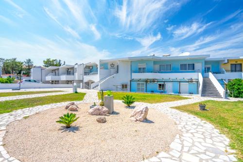 a large building with rocks in front of it at Mando Living -Faliraki in Faliraki