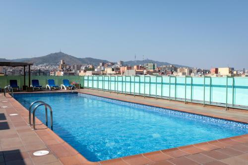 a swimming pool on the roof of a building at Apartamentos Aura Park Fira BCN in Hospitalet de Llobregat