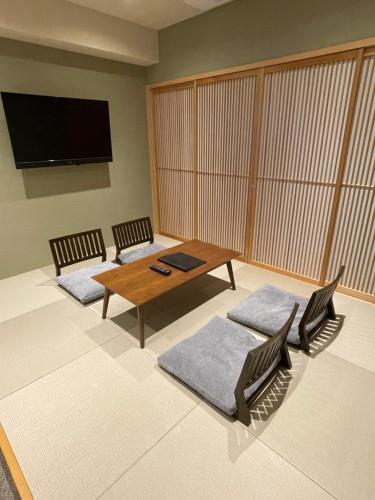 a living room with two chairs and a table at Sakura Cross Hotel Kyoto Kiyomizu in Kyoto