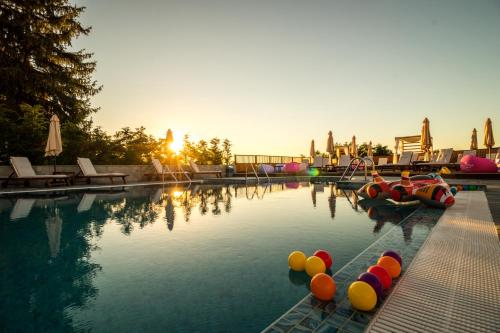 a swimming pool with colorful balls in the water at EMAR HOTEL & SPA in Sapareva Banya