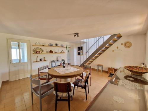 a dining room with a table and chairs and a staircase at House Nono Bepo in small Istrian village - Kuca Nono Bepo u mirnom istarskom selu in Brtonigla