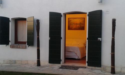 a room with a door with a bed in it at Agriturismo Corte Del Brenta in Oriago Di Mira
