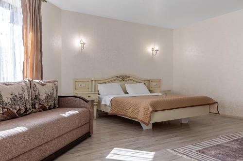 a bedroom with a bed and a couch at Premium hotel & SPA in Bukovel