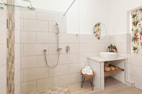 a bathroom with a shower and a sink at Cliff Cottage Hermanus in Hermanus