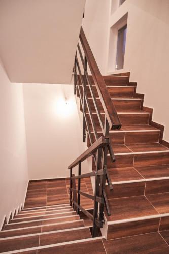 a staircase in a house with wooden flooring at Apartmani ZAT in Soko Banja