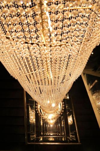 a large chandelier hanging from a ceiling at Ethnotel, Kolkata Airport in Kolkata
