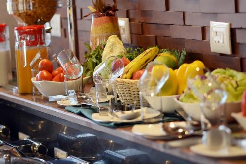 a buffet with fruits and vegetables on a table at Ethnotel, Kolkata Airport in Kolkata