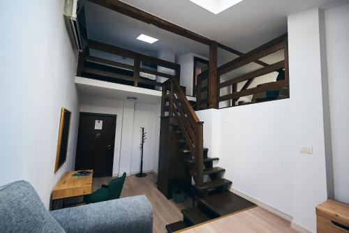 a living room with a staircase and a couch at Residence Villa Barrio in Bucharest