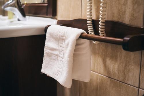 a towel hanging on a towel rack next to a sink at Residence Villa Barrio in Bucharest