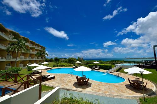 a pool with chairs and umbrellas in a resort at EXES Ishigaki in Ishigaki Island