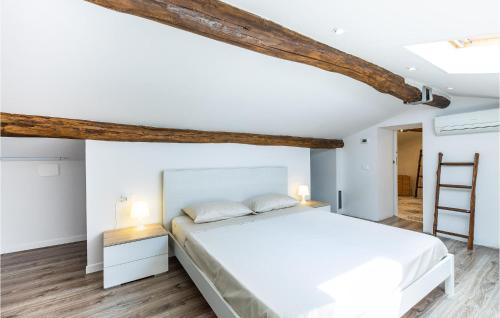 a bedroom with a white bed and wooden beams at 3 Bedroom Stunning Home In Marliana in Marliana