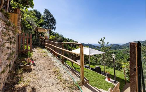 a garden with a fence and an umbrella at 3 Bedroom Stunning Home In Marliana in Marliana