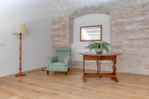 a room with a chair and a table and a lamp at Villa Vetta Marina - My Extra Home in Sirolo