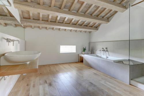 a bathroom with a tub and a sink and a mirror at Villa Vetta Marina - My Extra Home in Sirolo