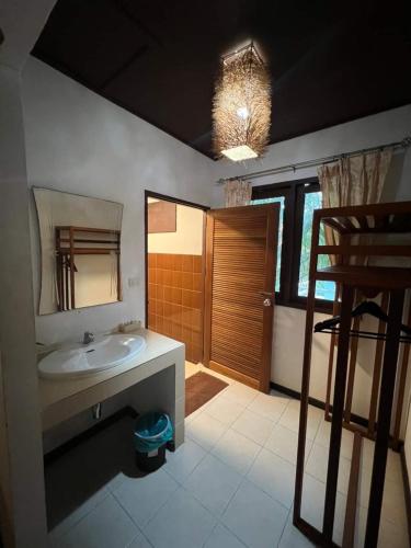 a bathroom with a sink and a mirror at Sonic Hill Koh Phangan in Haad Rin