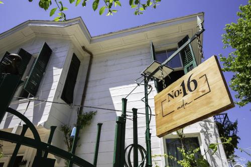 a sign in front of a white house at No16 Ada in Adalar