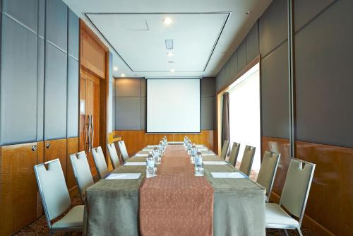 a conference room with a long table and chairs at Novotel Kuala Lumpur City Centre in Kuala Lumpur