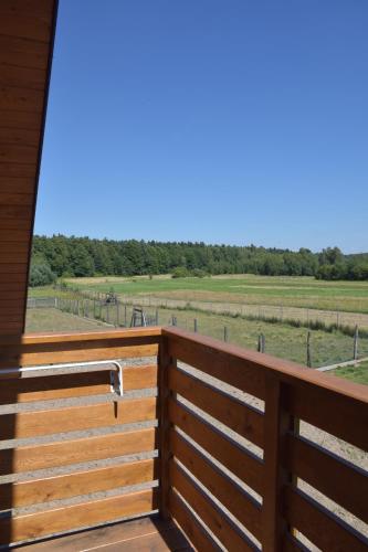 a view from the deck of a horse pasture at Noclegi Święta Katarzyna ,, Pod Jeleniami "prawdziwymi in Święta Katarzyna