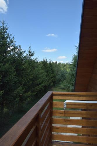 a wooden balcony with a view of a forest at Noclegi Święta Katarzyna ,, Pod Jeleniami "prawdziwymi in Święta Katarzyna