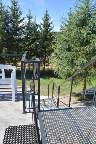 a set of stairs with a gate and trees at Noclegi Święta Katarzyna ,, Pod Jeleniami "prawdziwymi in Święta Katarzyna