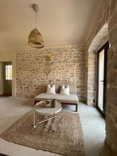 a living room with a couch and a table at Villa Kapela in Zlarin