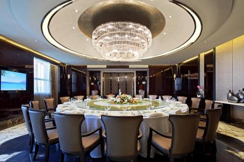 a large table in a room with a chandelier at Ramada Changzhou North Hotel in Changzhou