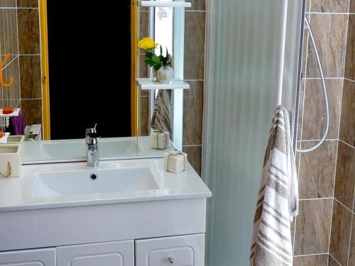 a bathroom with a sink and a mirror at Studio Bagnères-de-Luchon, 1 pièce, 2 personnes - FR-1-313-120 in Luchon