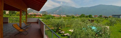 a balcony with two chairs and a view of a mountain at Agriturismo Maso Bergot in Arco