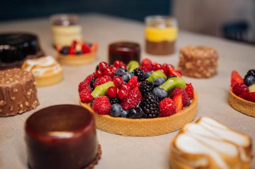a bowl of fruit on a table with desserts at Gustificio in Carmignano di Brenta