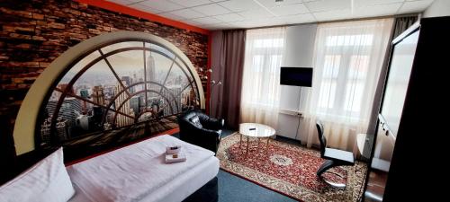 a hotel room with a bed and a large window at Rothenberger in Chemnitz