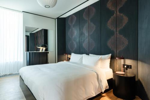 a bedroom with a white bed and a black wall at Tsinandali Estate Villa Collection in Tsinandali