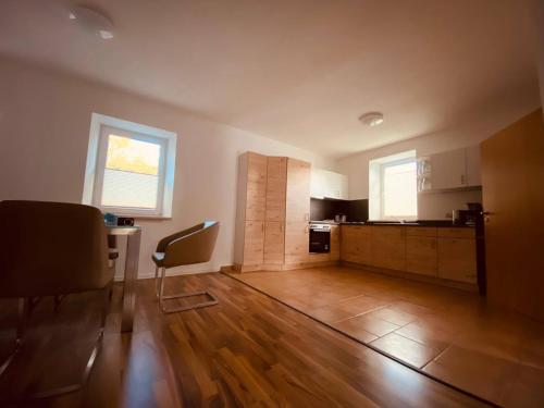 an empty room with a kitchen and a dining room at Ferienwohnung Nennigmühle 