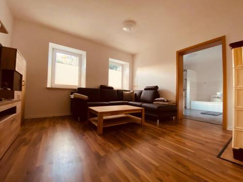 a living room with a couch and a table at Ferienwohnung Nennigmühle 