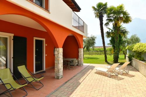 a patio of a house with chairs and a table at Agriturismo Maso Bergot in Arco